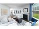 Cozy living room features a fireplace, neutral furniture, stylish decor and a large window offering plenty of natural light at 134 Falling Up Ln, Salisbury, NC 28147