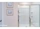 Modern shower features glass doors, built in shelves, sleek hardware, and bright interior lighting at 134 Falling Up Ln, Salisbury, NC 28147