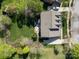 An aerial view of the house showcases a spacious backyard, patio area, and surrounding mature trees in a peaceful setting at 135 Northbridge Dr, Mooresville, NC 28115