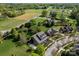 An aerial view displays a well-manicured lawn, mature trees, and the architectural layout of the property and its surroundings at 135 Northbridge Dr, Mooresville, NC 28115