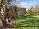 A peaceful backyard with a brick home, beautiful landscaping, and a patio area perfect for relaxation at 135 Northbridge Dr, Mooresville, NC 28115