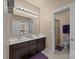 Bathroom with double sinks, dark wood cabinets, and a separate toilet room at 135 Northbridge Dr, Mooresville, NC 28115