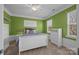 Bright bedroom with a white bed frame, green walls, and lots of natural light at 135 Northbridge Dr, Mooresville, NC 28115