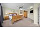 Spacious bedroom featuring a wood bed frame, ceiling fan, and carpeted floors at 135 Northbridge Dr, Mooresville, NC 28115