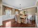Elegant dining room with hardwood floors, large windows, and sophisticated decor at 135 Northbridge Dr, Mooresville, NC 28115