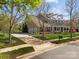 Gorgeous home boasting a manicured lawn, brick facade, covered porch, attached garage, and long driveway at 135 Northbridge Dr, Mooresville, NC 28115