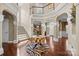 Stunning two-story foyer features a staircase, columns, hardwood flooring, and elegant decor at 135 Northbridge Dr, Mooresville, NC 28115