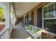 Inviting covered front porch with white columns, comfortable seating, and charming decor at 135 Northbridge Dr, Mooresville, NC 28115