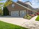 Spacious two-car garage with brick exterior and well-manicured landscaping at 135 Northbridge Dr, Mooresville, NC 28115