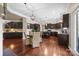 Eat-in kitchen boasts dark wood cabinets, modern lighting, and an open concept; great for gatherings at 135 Northbridge Dr, Mooresville, NC 28115