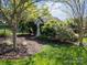 Charming shed surrounded by lush landscaping, blending seamlessly into the serene backyard setting at 135 Northbridge Dr, Mooresville, NC 28115