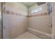 Walk-in shower with tiled walls, built-in bench, and modern fixtures at 135 Northbridge Dr, Mooresville, NC 28115