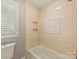 Bathroom featuring a tiled shower and tub combo with a convenient built-in alcove for toiletries at 1413 Willow Oaks Trl, Weddington, NC 28104