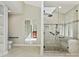 Bathroom featuring glass shower with grab bars, accessible toilet, and a bright, open design for comfortable living at 1413 Willow Oaks Trl, Weddington, NC 28104