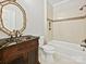 Bathroom showcasing a dark wood vanity with a vessel sink, tile accents and a tub with shower at 1413 Willow Oaks Trl, Weddington, NC 28104