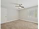 Neutral bedroom features plush carpeting, a ceiling fan, and plantation shutters on the window at 1413 Willow Oaks Trl, Weddington, NC 28104