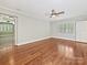 Large bedroom with hardwood floors, complemented by an open-concept design and natural light from the windows at 1413 Willow Oaks Trl, Weddington, NC 28104