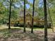 Charming brick two-story home surrounded by mature trees and lush landscaping at 1413 Willow Oaks Trl, Weddington, NC 28104