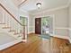 Open foyer features hardwood floors, staircase, and front door view at 1413 Willow Oaks Trl, Weddington, NC 28104