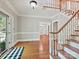 Bright foyer with hardwood floors, staircase, and paneled front door at 1413 Willow Oaks Trl, Weddington, NC 28104