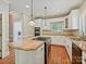 Bright kitchen featuring white cabinets, light granite countertops, wood floors and stainless appliances at 1413 Willow Oaks Trl, Weddington, NC 28104