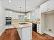 Bright kitchen featuring white cabinets, light granite countertops, wood floors and stainless appliances at 1413 Willow Oaks Trl, Weddington, NC 28104