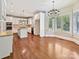 Bright kitchen with white cabinets, granite countertops, stainless appliances and adjacent dining area at 1413 Willow Oaks Trl, Weddington, NC 28104