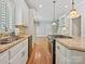Bright kitchen with white cabinets, granite countertops, stainless appliances and wood floors at 1413 Willow Oaks Trl, Weddington, NC 28104