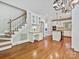 View of the kitchen from the living space with bright light, wood floors and white cabinets at 1413 Willow Oaks Trl, Weddington, NC 28104