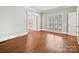 Bright living room featuring hardwood floors and white trim, offering a cozy and inviting space at 1413 Willow Oaks Trl, Weddington, NC 28104
