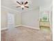 Spacious living room featuring plush carpet, neutral tones, and an open layout to an adjacent room at 1413 Willow Oaks Trl, Weddington, NC 28104