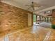 The patio features a brick accent wall, ceiling fans, and beautiful tile flooring at 1413 Willow Oaks Trl, Weddington, NC 28104