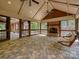 This screened in porch has a stone floor, brick fireplace and rustic swing at 1413 Willow Oaks Trl, Weddington, NC 28104