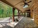 Relaxing outdoor space with brick and timber accents, brick pavers, and ceiling fans at 1413 Willow Oaks Trl, Weddington, NC 28104