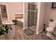 Bathroom featuring a soaking tub, a tiled glass shower, granite counter tops, and wooden-look tile flooring at 143 S Gibbs Rd, Mooresville, NC 28117