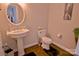 Cozy powder room showcasing a pedestal sink, standard toilet, and minimal decor at 143 S Gibbs Rd, Mooresville, NC 28117