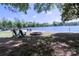 Lakefront property with sandy beach, firepit, and Adirondack chairs ready for relaxing at 143 S Gibbs Rd, Mooresville, NC 28117