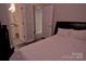Cozy bedroom with white bedding and a view to the adjacent bathroom at 143 S Gibbs Rd, Mooresville, NC 28117