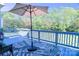 Relaxing outdoor deck with stylish furniture and a vibrant rug, perfect for enjoying the natural surroundings at 143 S Gibbs Rd, Mooresville, NC 28117