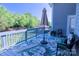 Inviting outdoor deck with comfortable seating, an umbrella, and a peaceful view of the backyard greenery at 143 S Gibbs Rd, Mooresville, NC 28117