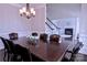 Formal dining room with dark wood table and view of the staircase and fireplace at 143 S Gibbs Rd, Mooresville, NC 28117
