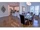 Open dining area with glass table and adjacent kitchen featuring stainless steel appliances and barstool seating at 143 S Gibbs Rd, Mooresville, NC 28117