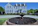 Elegant two-story home with manicured landscaping, circular driveway, and decorative fountain at 143 S Gibbs Rd, Mooresville, NC 28117