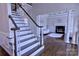 Elegant staircase and foyer leading into the living room with fireplace at 143 S Gibbs Rd, Mooresville, NC 28117