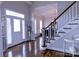 Inviting foyer featuring hardwood floors, staircase, and entry to living spaces at 143 S Gibbs Rd, Mooresville, NC 28117