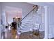 Spacious foyer featuring hardwood floors, staircase, and entry to dining at 143 S Gibbs Rd, Mooresville, NC 28117