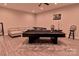 Spacious game room featuring a pool table, poker table, and comfortable seating area for entertaining guests at 143 S Gibbs Rd, Mooresville, NC 28117