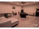 Entertaining game room with a pool table, poker table, arcade game, and comfortable sofa at 143 S Gibbs Rd, Mooresville, NC 28117