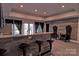 Modern kitchen bar with granite countertop, black stools, and elegant arm chairs, illuminated by recessed lighting at 143 S Gibbs Rd, Mooresville, NC 28117