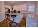 Bright kitchen with granite countertops, barstool seating, and stainless steel appliances at 143 S Gibbs Rd, Mooresville, NC 28117